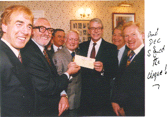 Dec and his pals hand over a sizable cheque to Right Hon. John Major on the Queen's Christmas Day TV message....and guess who signed the cheque?